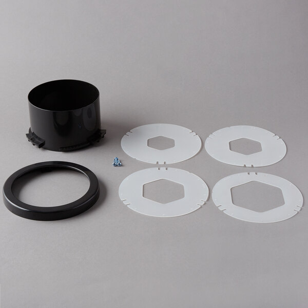 A black plastic ring with white circles and a black ring.