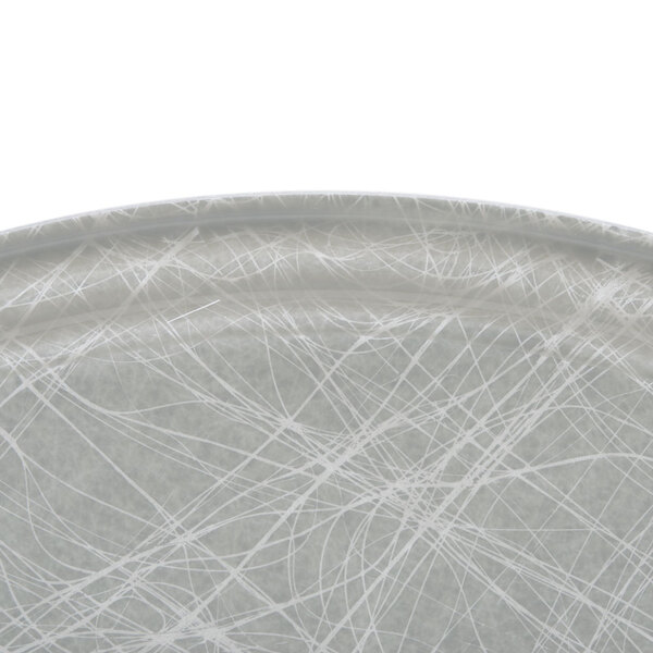 An oval gray Cambro cafeteria tray with white abstract lines.