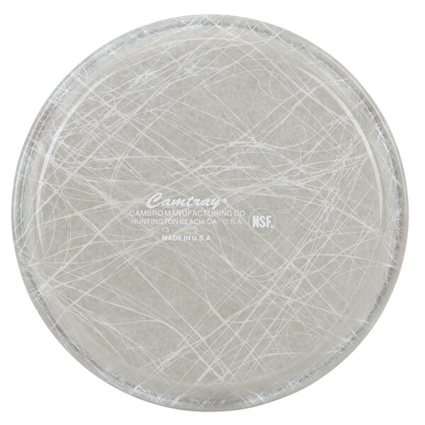 A close-up of a Cambro round gray fiberglass tray with an abstract design.