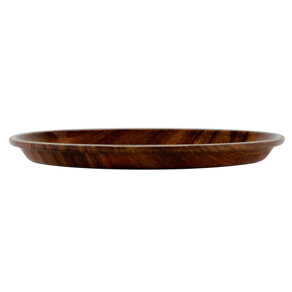 A Cambro round fiberglass tray with a Burma Teak wooden surface.
