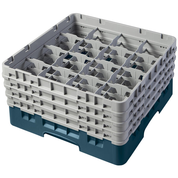 A teal plastic Cambro glass rack with many compartments and extenders.