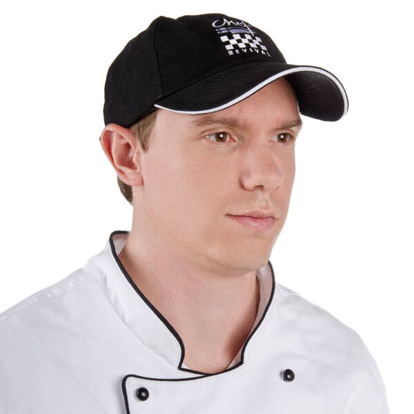 A man wearing a black Chef Revival baseball cap with a white logo.