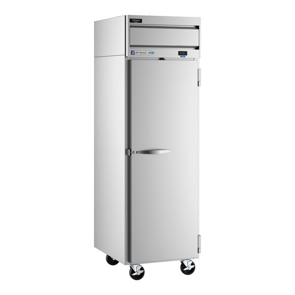 A commercial stainless steel reach-in freezer with a solid door and caster wheels.