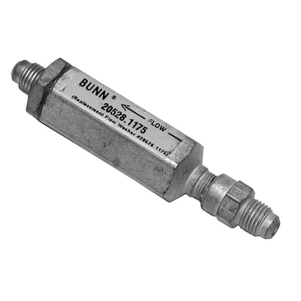 A close-up of a rectangular metal flow control assembly with a label.