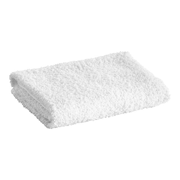 A folded white textured terry towel is shown against a plain background.