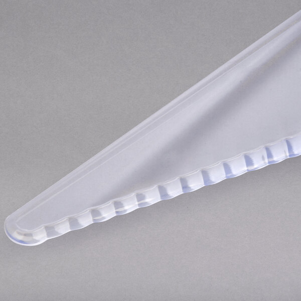 A clear plastic triangle shaped pie server with a plastic handle.