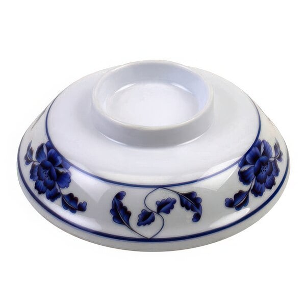 A white melamine bowl with blue flowers and blue trim with a close up of a white and blue bowl with blue flowers.