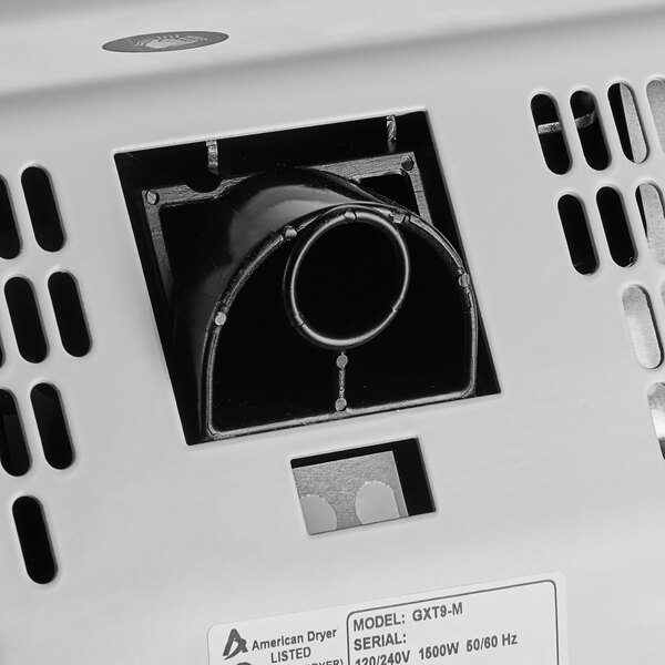 An American Dryer GXT9-M automatic hand dryer with a white cover.