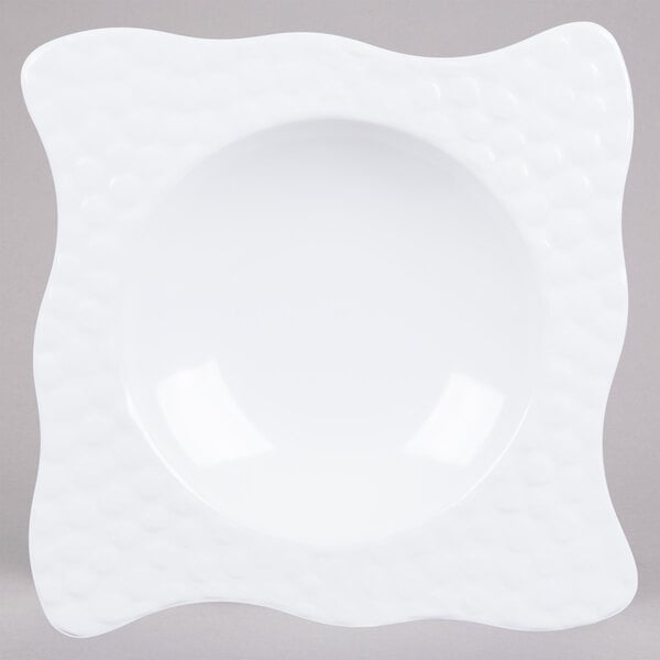 A white square melamine bowl with a wavy edge.