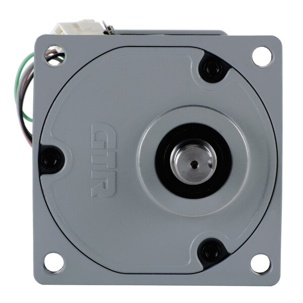 A close-up of a small grey metal Cornelius gear motor kit with wires.