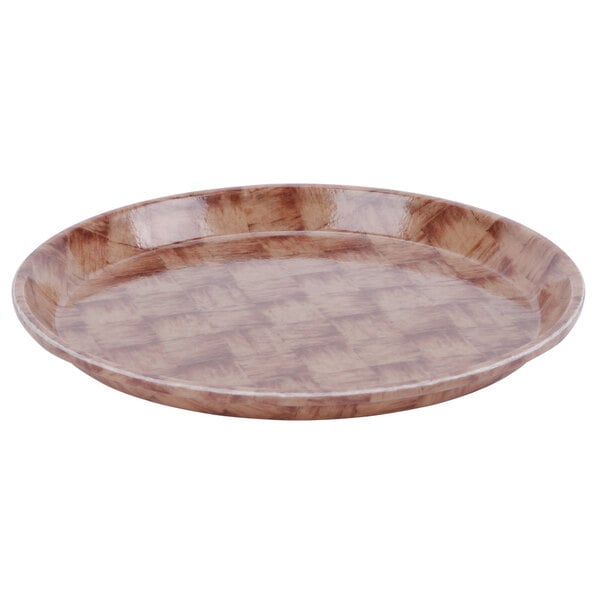 A brown Cambro round fiberglass tray with a basketweave pattern.