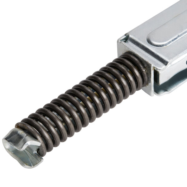 A close-up of a TurboChef door hinge with a metal piece and a metal spring.