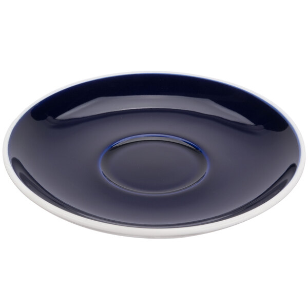 A blue and white saucer with a blue circle in the middle.