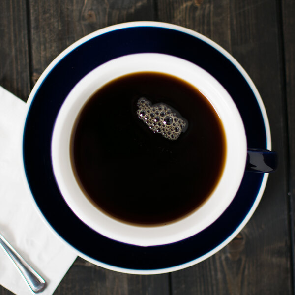 A CAC Venice blue cup of coffee on a saucer