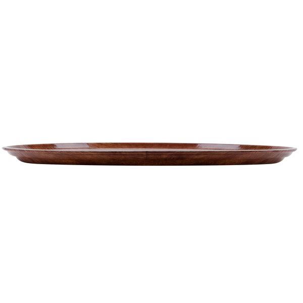 A brown oval Cambro fiberglass tray with a wood grain finish.