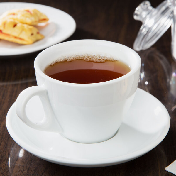 A CAC white cup of tea on a saucer.