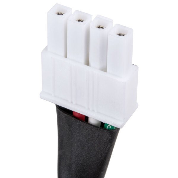 A close-up of a white electrical plug with three white wires.