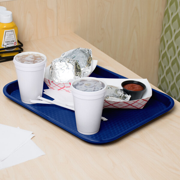 A cobalt blue GET fast food tray with food and a drink on a table.