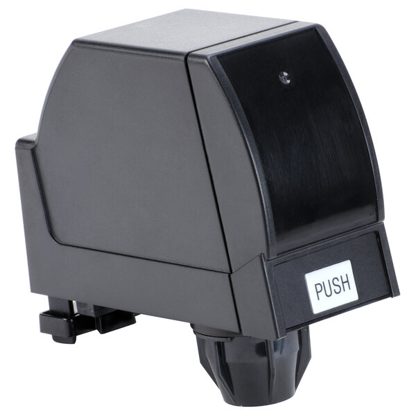 A black push button on a white background.