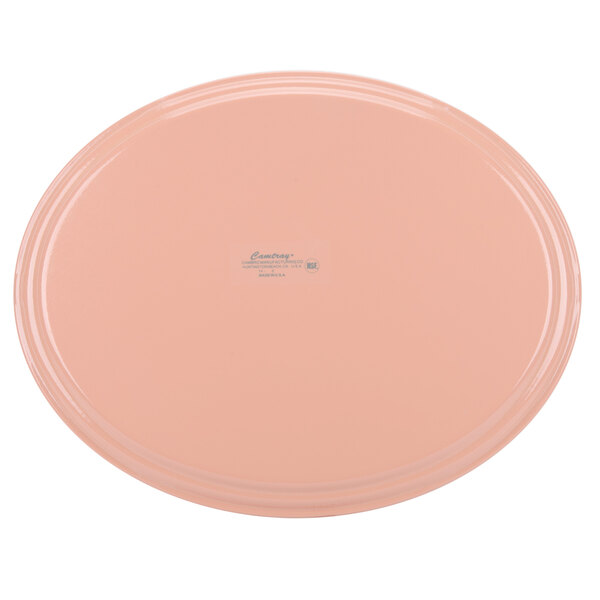 A dark peach oval fiberglass tray with a white border.
