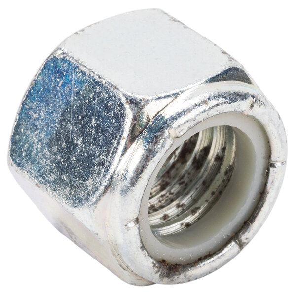 A close up of a metal nut with a white background.