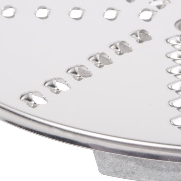 A close up of a Robot Coupe 5/32" stainless steel grating / shredding disc.