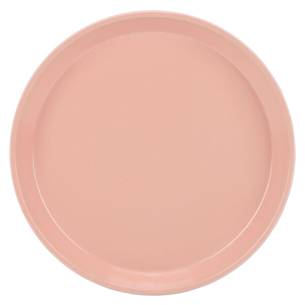 A close-up of a dark peach Cambro round tray.