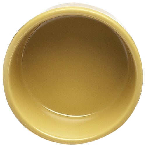 A close-up of a yellow Elite Global Solutions melamine ramekin.