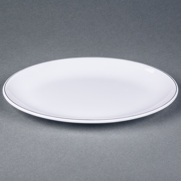 A white Elite Global Solutions oval plate with black trim.