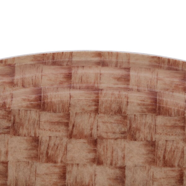 A brown oval Cambro Camtray with a basketweave pattern.