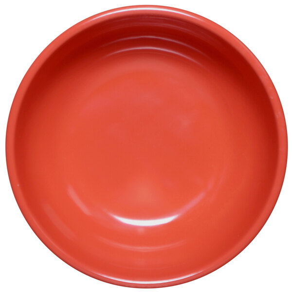 A close up of a red bowl with a white background.