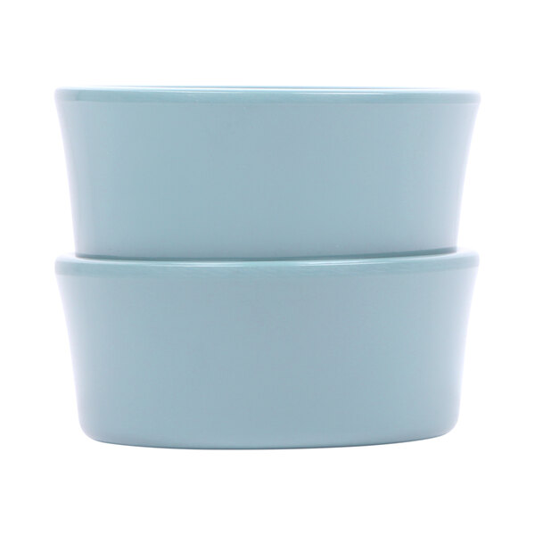 A close-up of two blue Elite Global Solutions melamine ramekins sitting on top of each other.