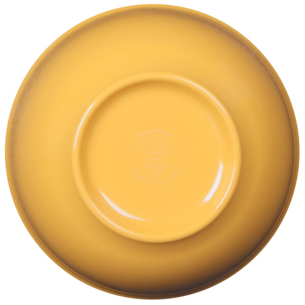 A yellow melamine bowl on a white surface.