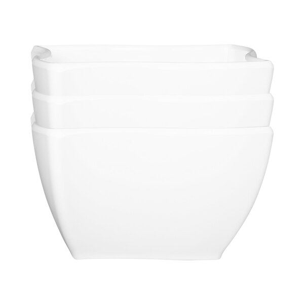 A stack of white square melamine bowls with a wavy design.