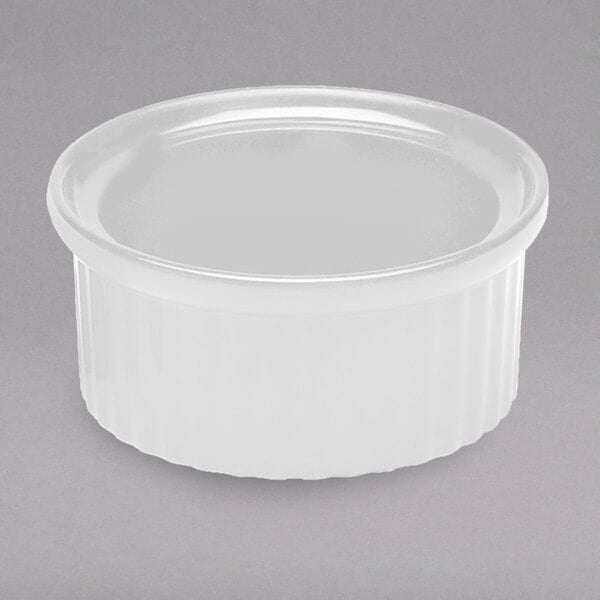 A white fluted melamine ramekin with a round rim.