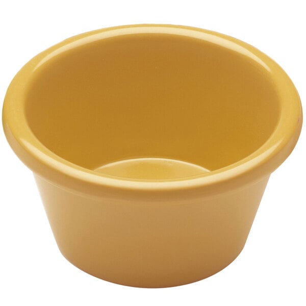 A close-up of a yellow Elite Global Solutions melamine ramekin.