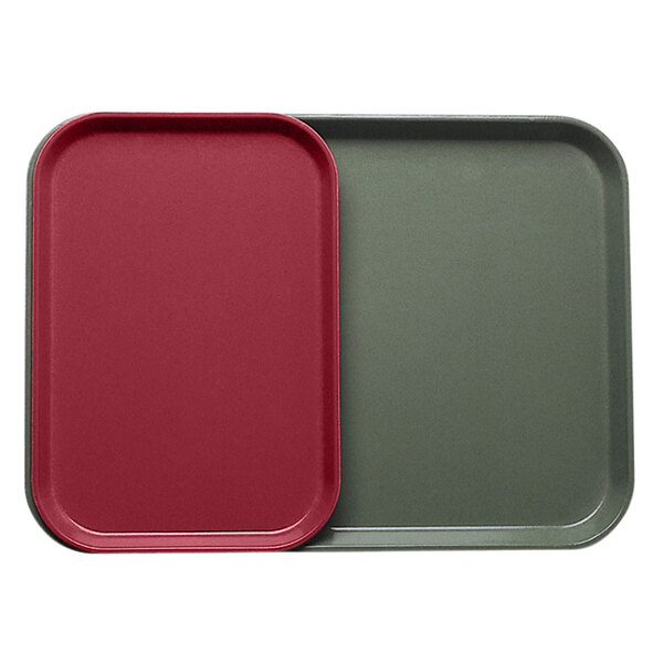 Two rectangular Cambro trays with red and green inserts on a table.