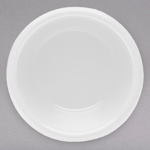 A white Elite Global Solutions melamine ramekin on a white plate.