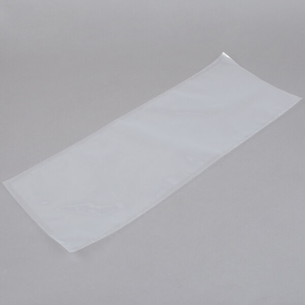 An ARY VacMaster clear plastic vacuum packaging bag on a gray surface.