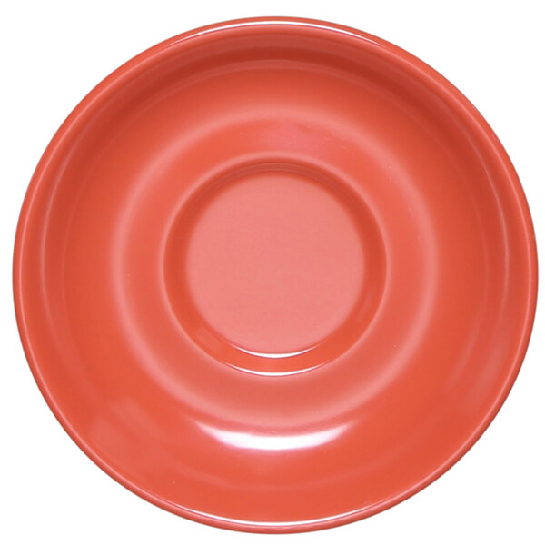 A close-up of a coral Elite Global Solutions melamine coffee saucer with a circle in the center.