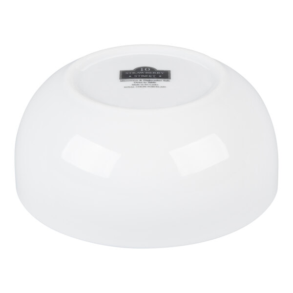 A white porcelain soup bowl turned upside down.