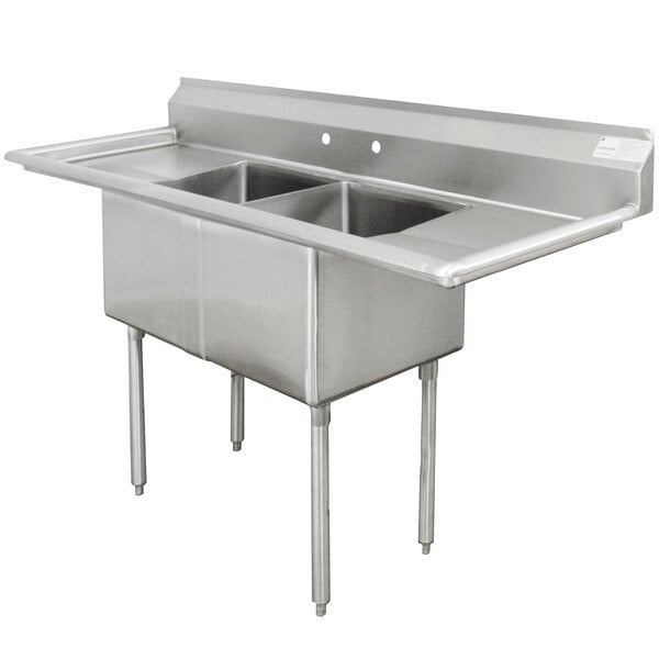 An Advance Tabco stainless steel sink with two bowls and two drainboards.