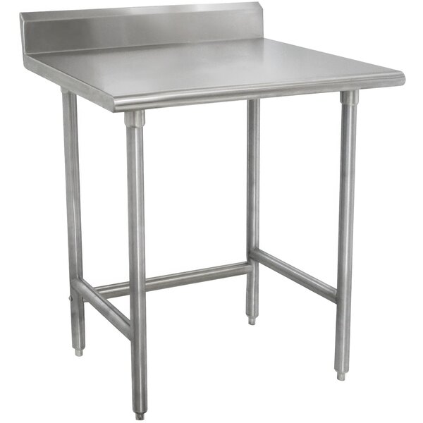 An Advance Tabco stainless steel work table with backsplash and stainless steel legs.