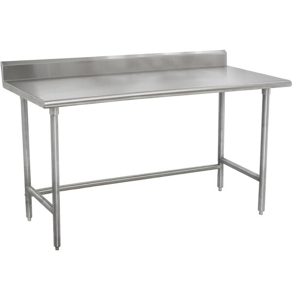 A stainless steel Advance Tabco work table with stainless steel top and backsplash.
