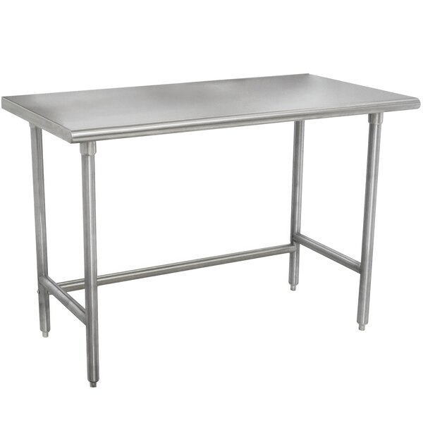 A silver Advance Tabco stainless steel work table with legs.