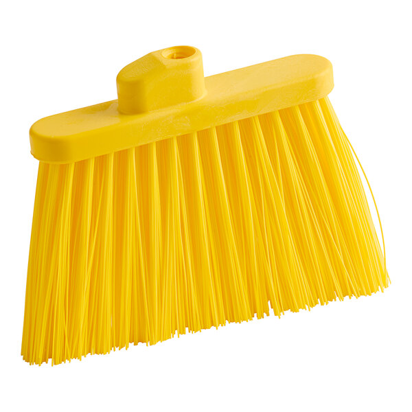 A close up of a yellow Carlisle Duo-Sweep broom head with long, unflagged bristles.