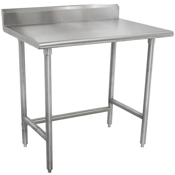 A stainless steel Advance Tabco work table with legs.