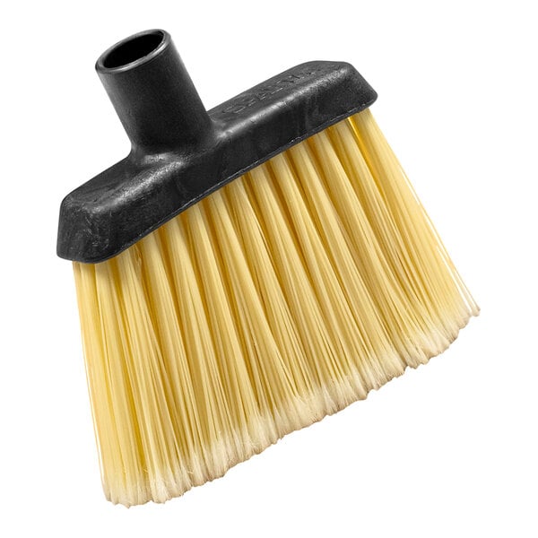 A close up of a Carlisle medium duty angled broom head with yellow flagged bristles.