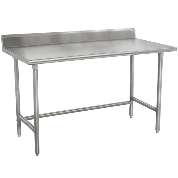 A stainless steel Advance Tabco work table with a 5" backsplash on a counter.
