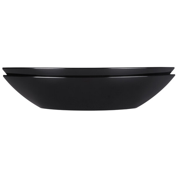 An Elite Global Solutions black melamine oval bowl with a curved edge.